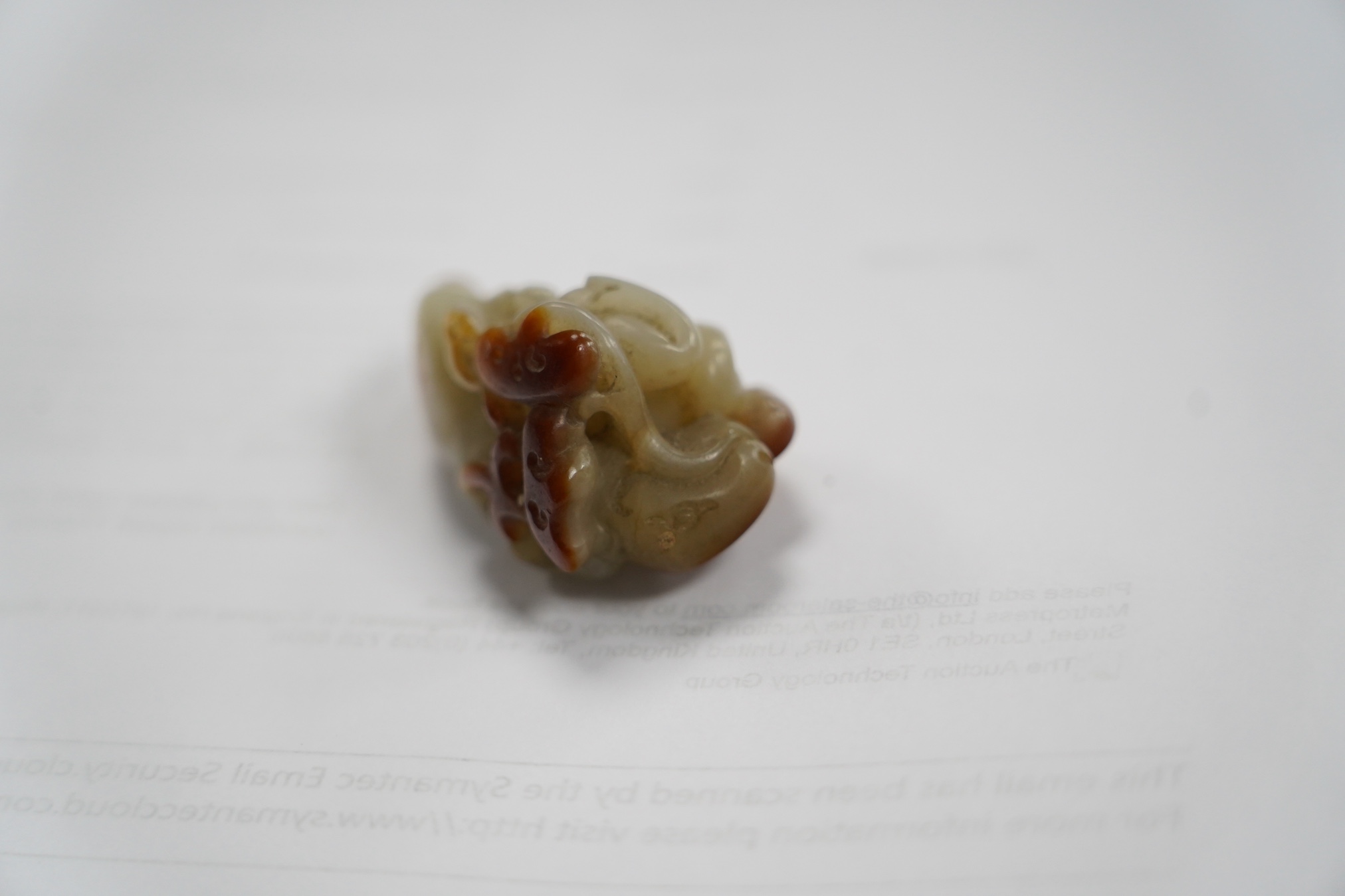 A Chinese pale celadon and russet skin jade figure of a stag, 19th century